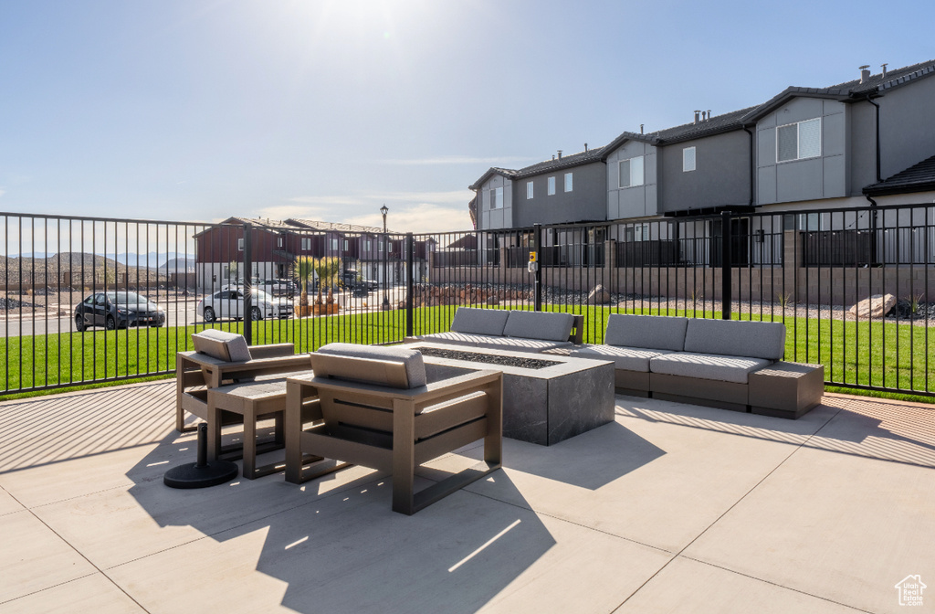 View of patio / terrace featuring an outdoor living space with a fire pit and a residential view