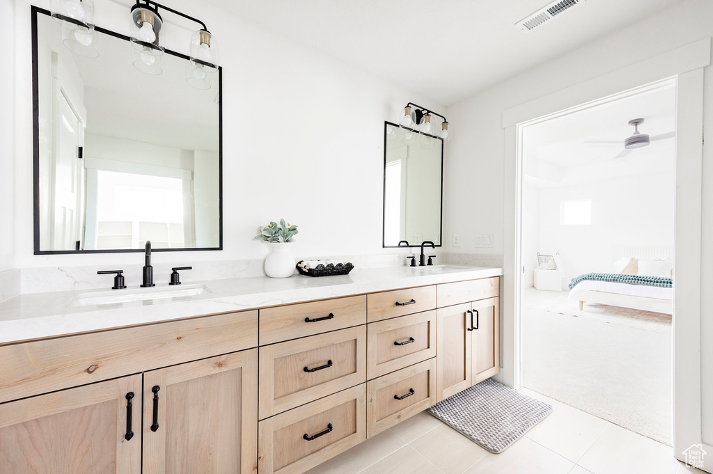 Bathroom featuring connected bathroom, double vanity, and tile patterned flooring