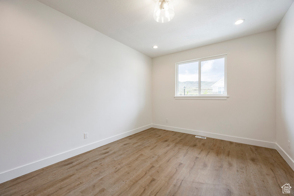 Spare room featuring light wood-style floors and recessed lighting