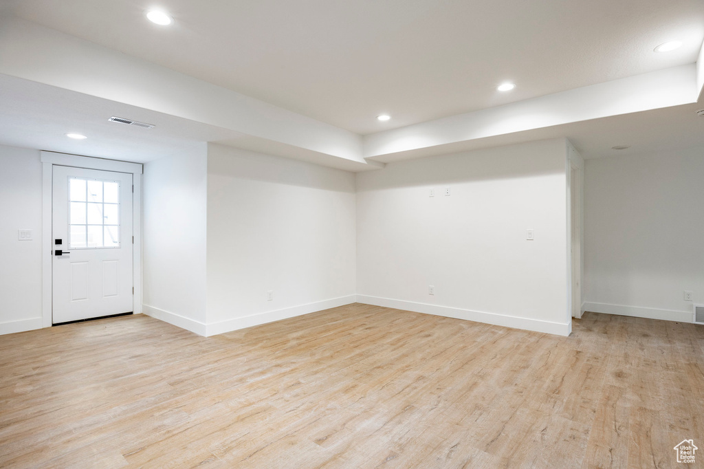 Below grade area featuring light wood-style flooring and recessed lighting