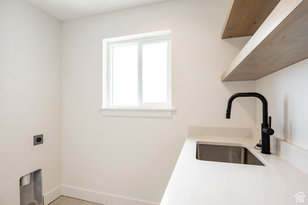 Washroom featuring electric dryer hookup and baseboards