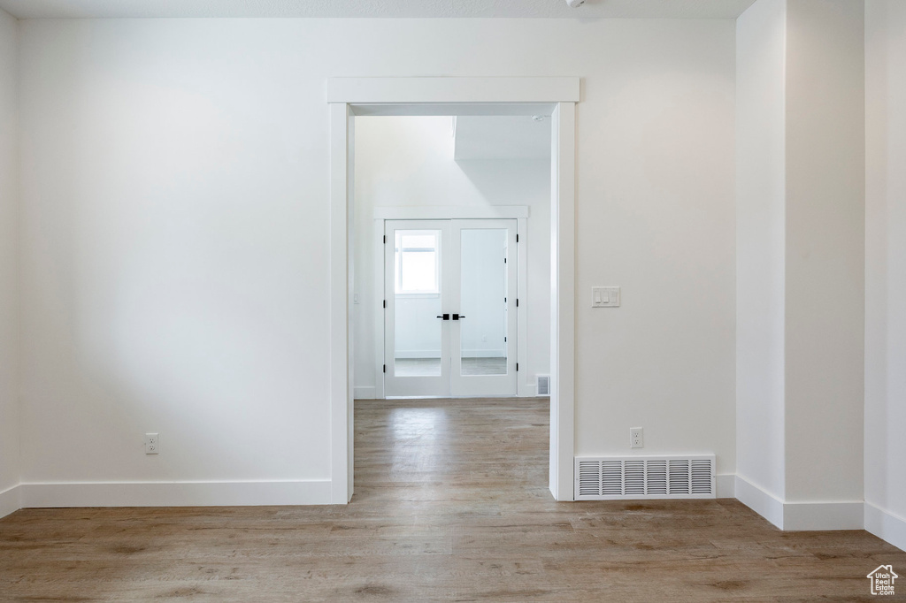 Spare room with light wood-type flooring and baseboards