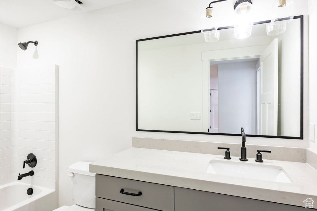 Full bath featuring vanity and shower / bath combination