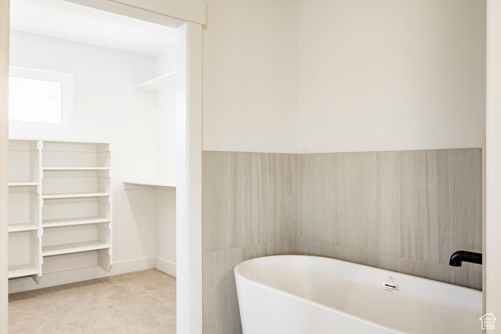 Bathroom featuring a freestanding bath and baseboards