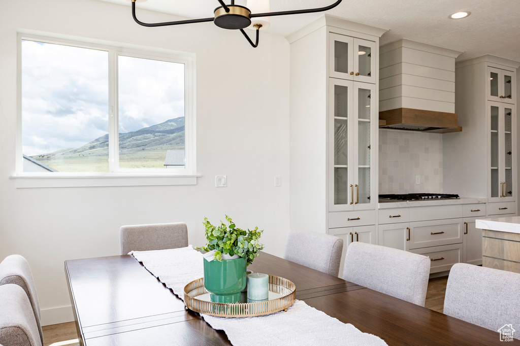 Dining area featuring healthy amount of natural light, ceiling fan, wood finished floors, recessed lighting, and a mountain view
