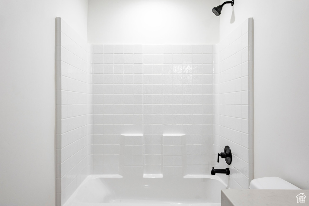 Full bathroom featuring shower / bath combination and toilet