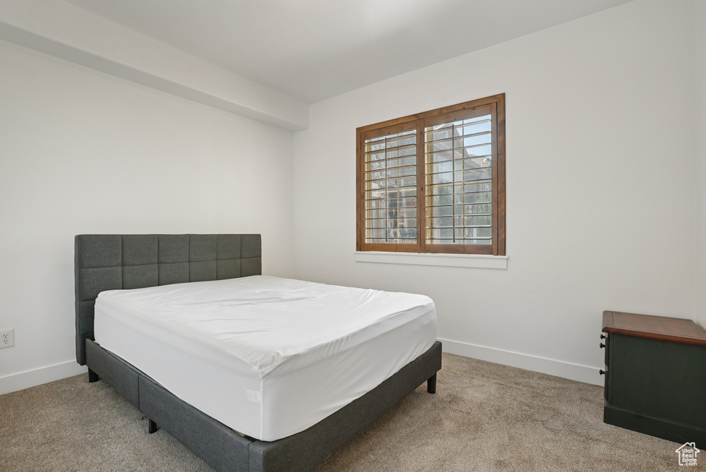 Carpeted bedroom featuring baseboards