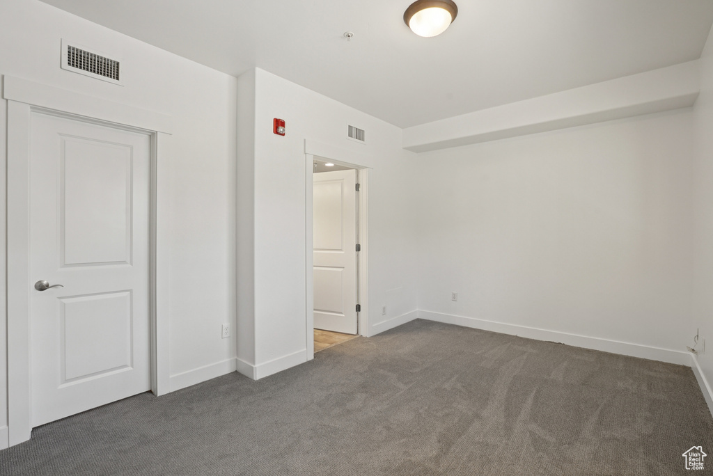 Unfurnished bedroom featuring carpet flooring and baseboards