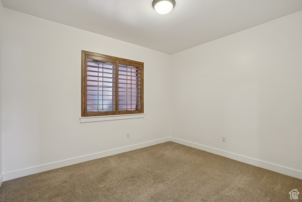 Unfurnished room with carpet floors and baseboards