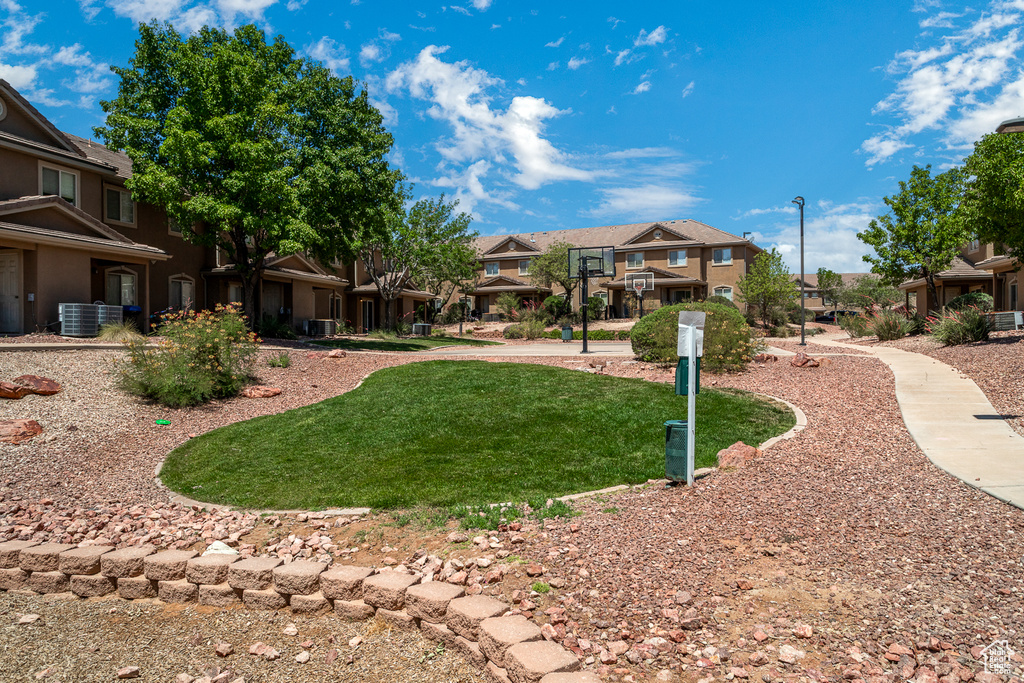 View of property's community featuring a residential view and a lawn