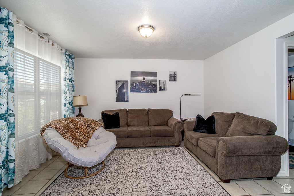 Living area featuring light tile patterned flooring
