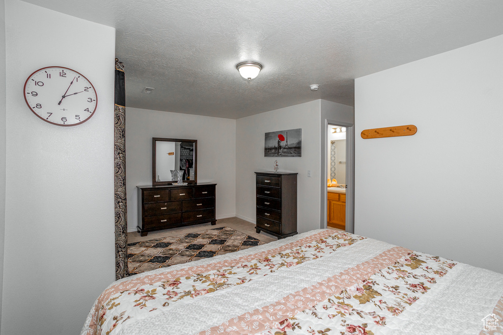 Carpeted bedroom featuring a textured ceiling