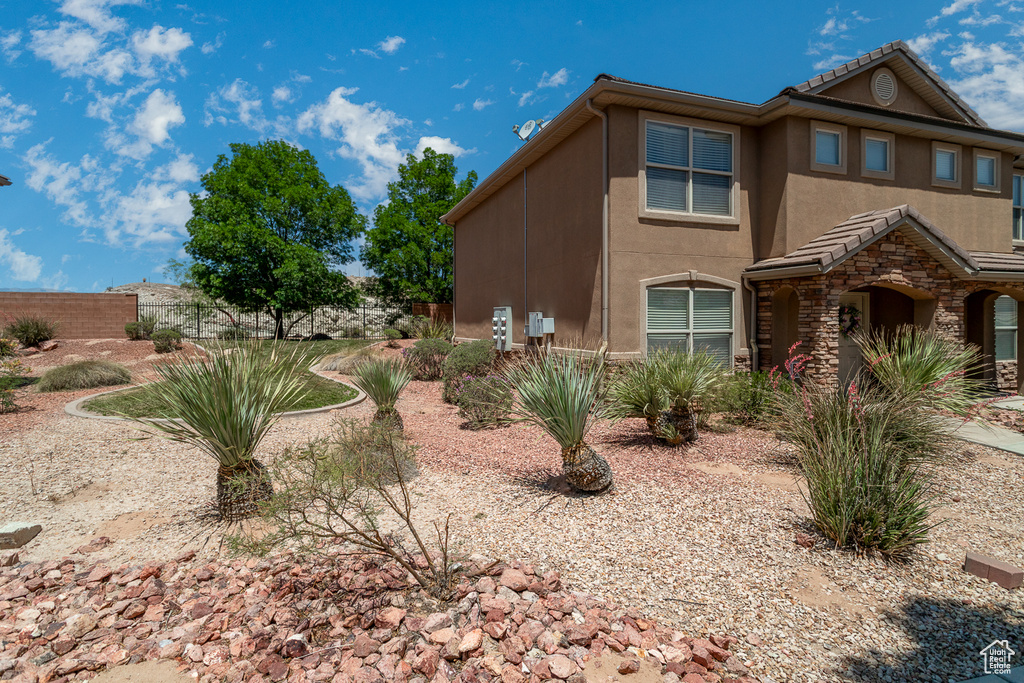 View of home's exterior featuring stucco siding and stone siding