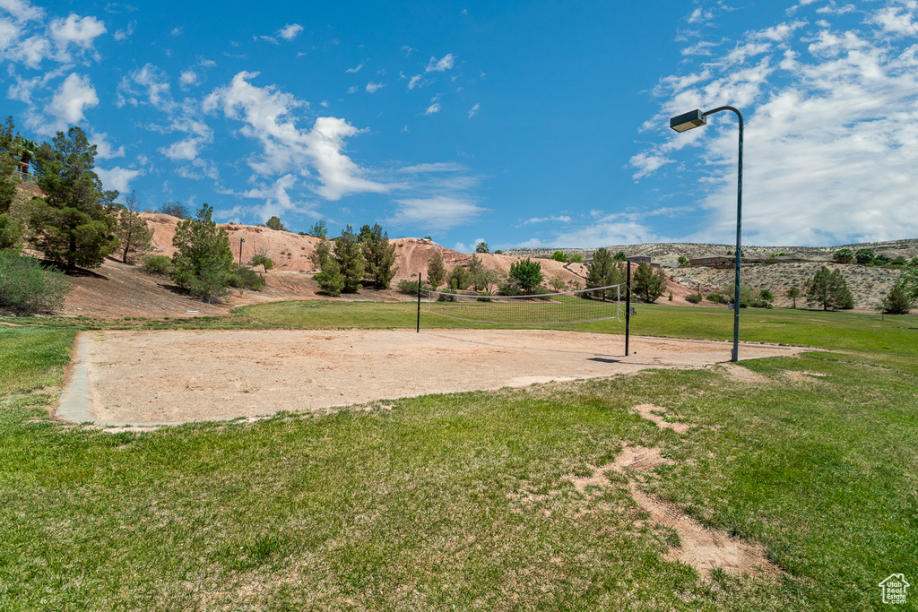 View of property's community with volleyball court, a yard, and a mountain view