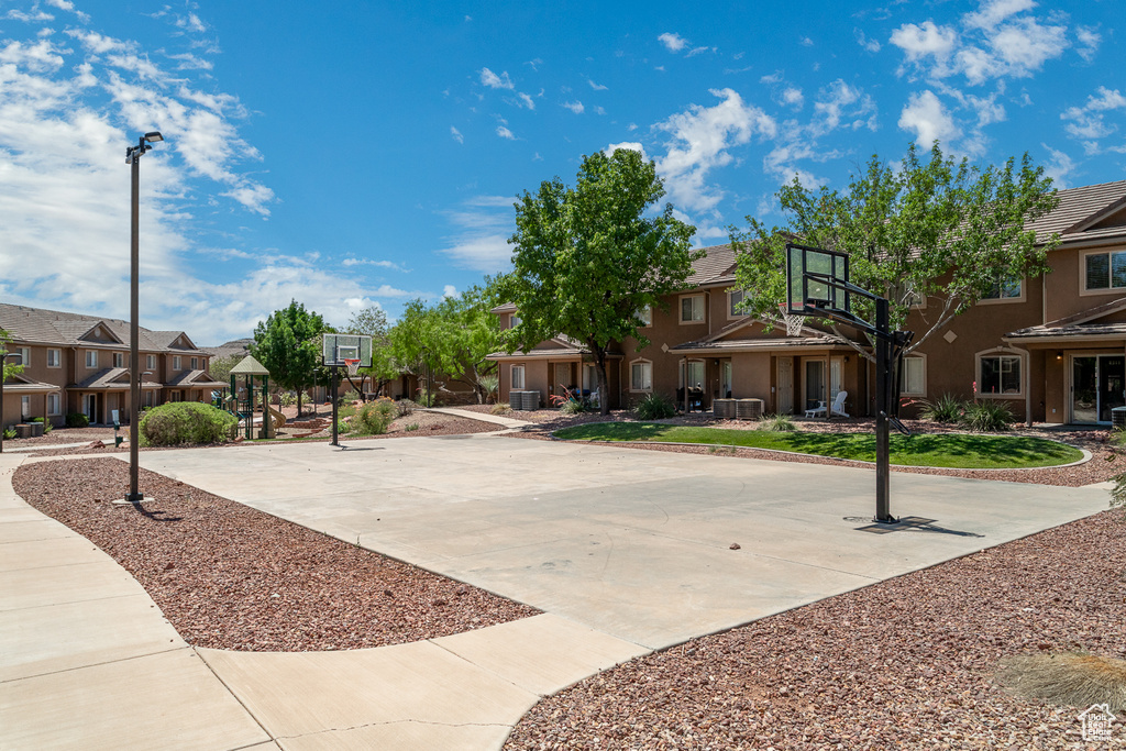 View of sport court featuring community basketball court and a residential view