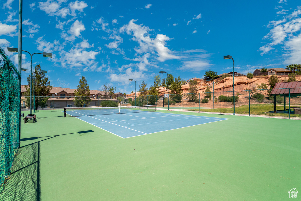 View of tennis court featuring community basketball court, a residential view, and a gazebo