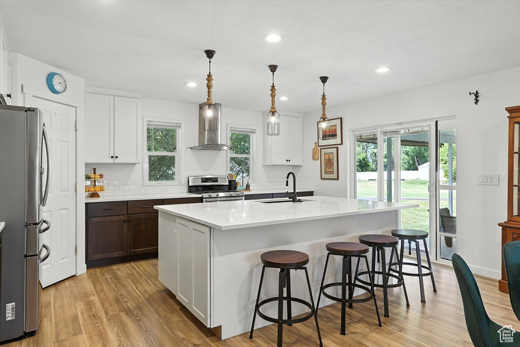 Kitchen featuring stainless steel appliances, light countertops, plenty of natural light, light wood-style flooring, and recessed lighting