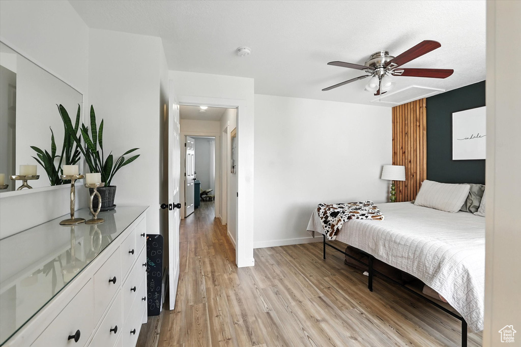 Bedroom with light wood finished floors and a ceiling fan