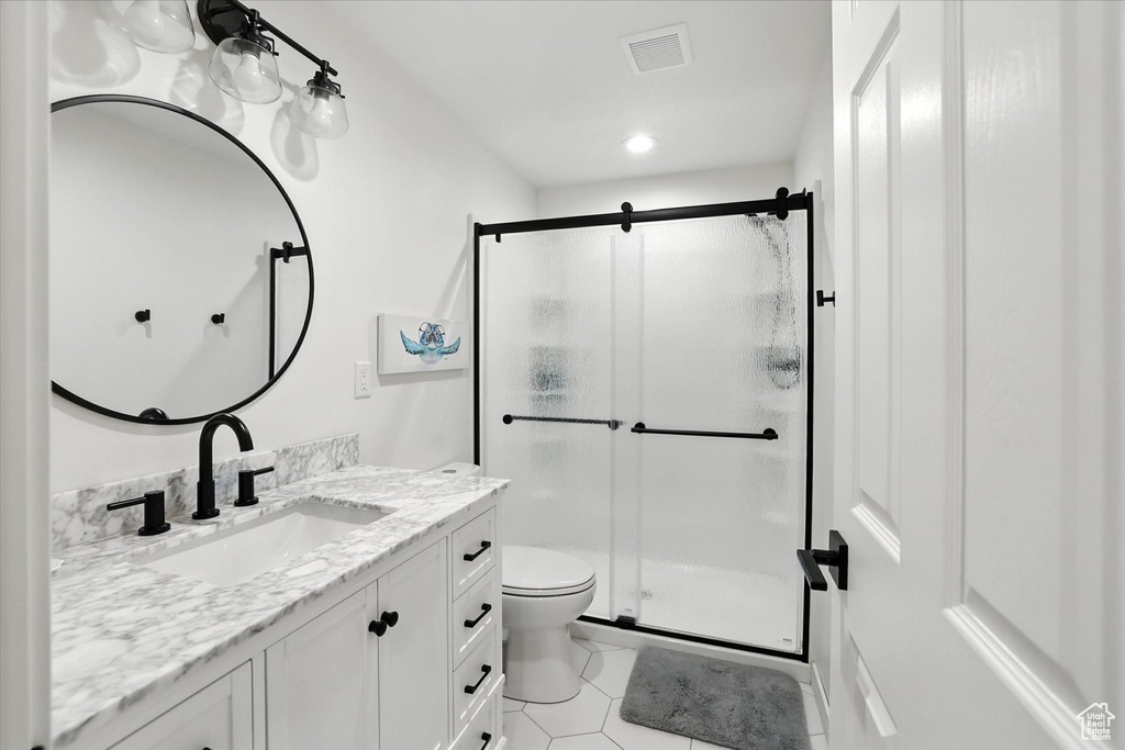 Bathroom with vanity, a stall shower, tile patterned flooring, and recessed lighting