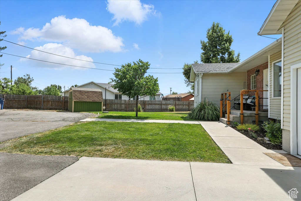 View of yard with a storage unit