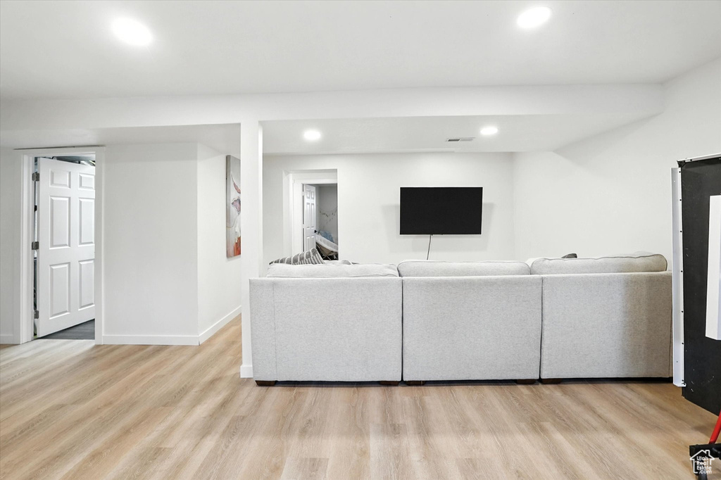Unfurnished living room featuring recessed lighting and wood finished floors