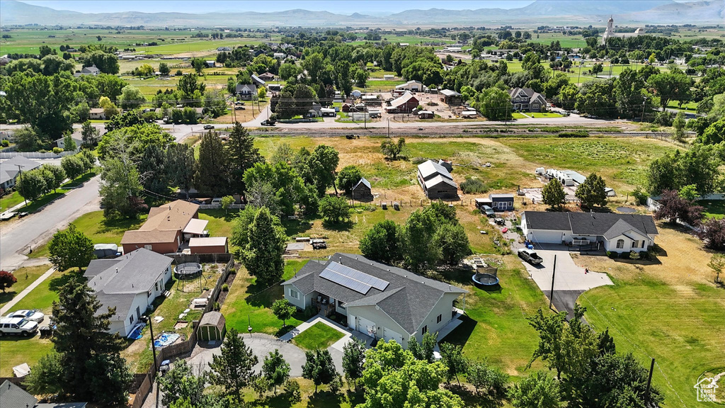 Aerial view of property's location featuring a mountainous background and nearby suburban area