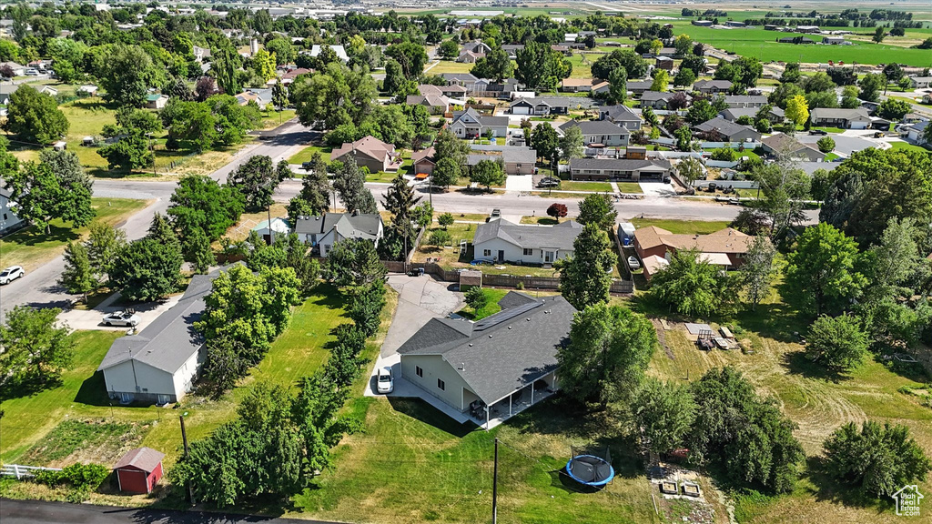 Aerial view of property and surrounding area featuring nearby suburban area