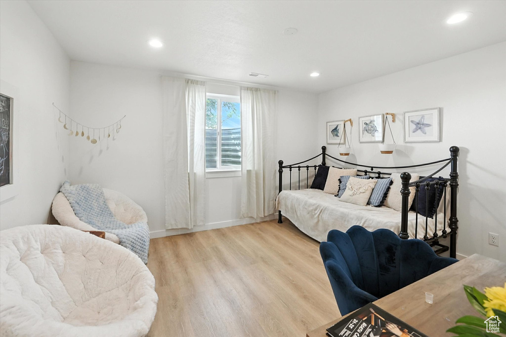 Bedroom with light wood finished floors and recessed lighting