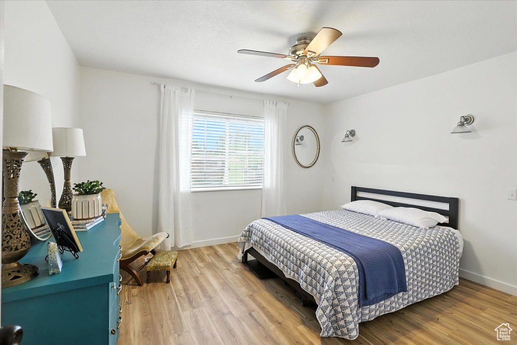 Bedroom featuring light wood-style flooring and a ceiling fan