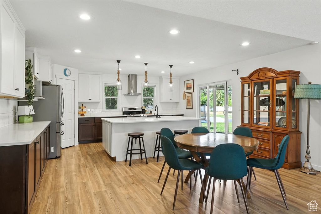 Dining area with recessed lighting and light wood-style floors