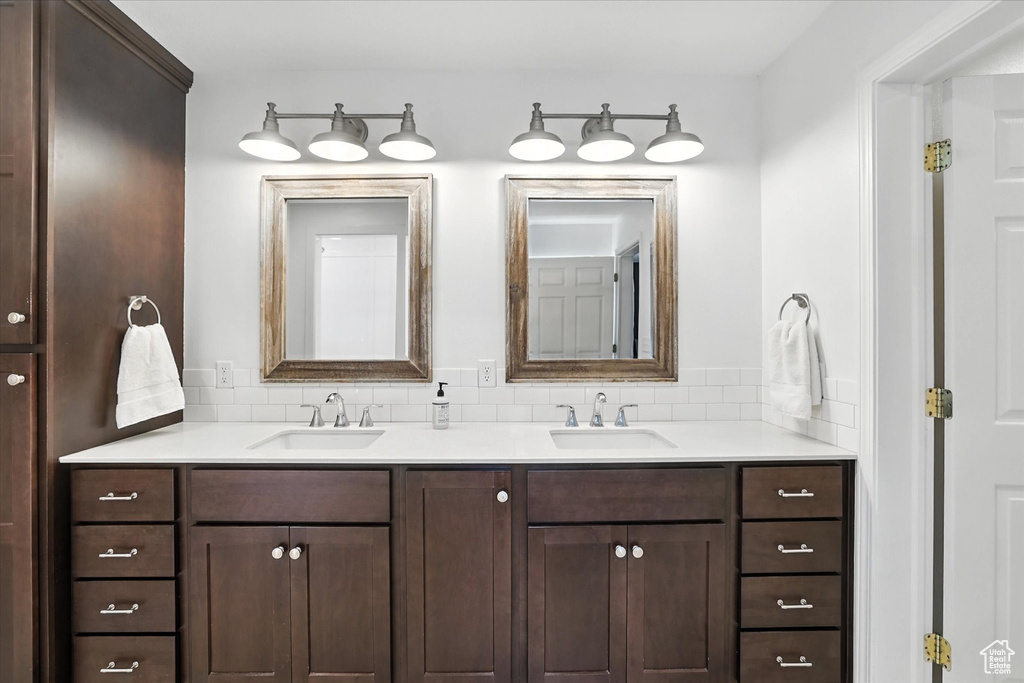 Full bath with double vanity and tasteful backsplash