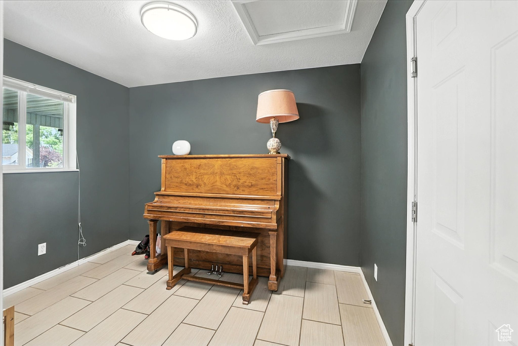 Living area with baseboards and attic access