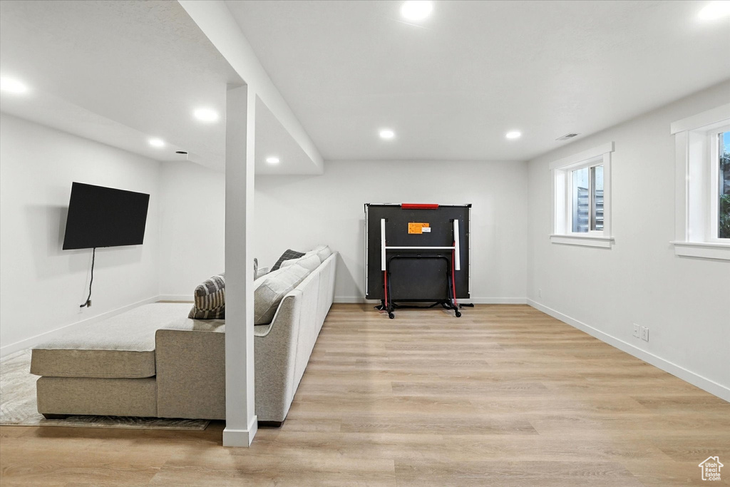 Living area with recessed lighting and light wood-style flooring