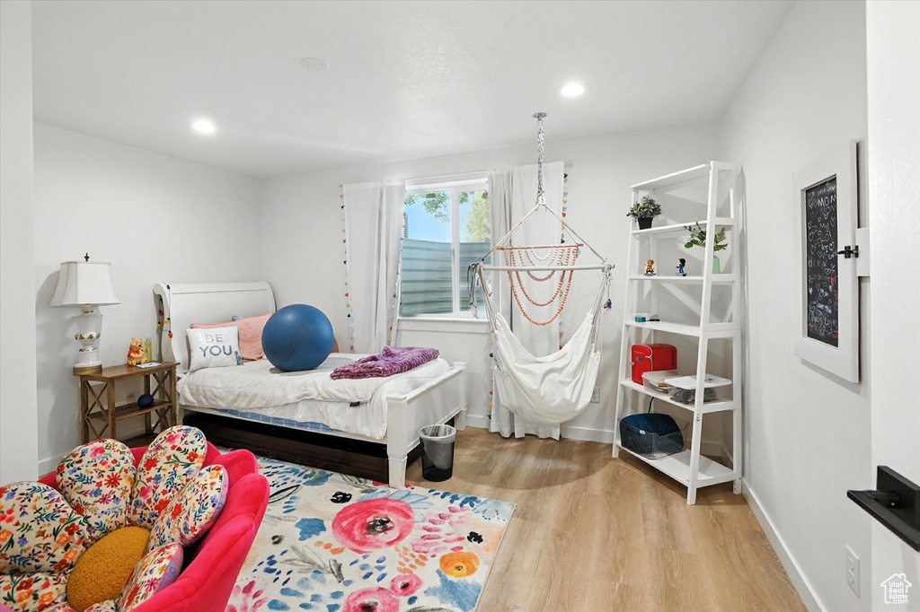 Bedroom with wood finished floors and recessed lighting