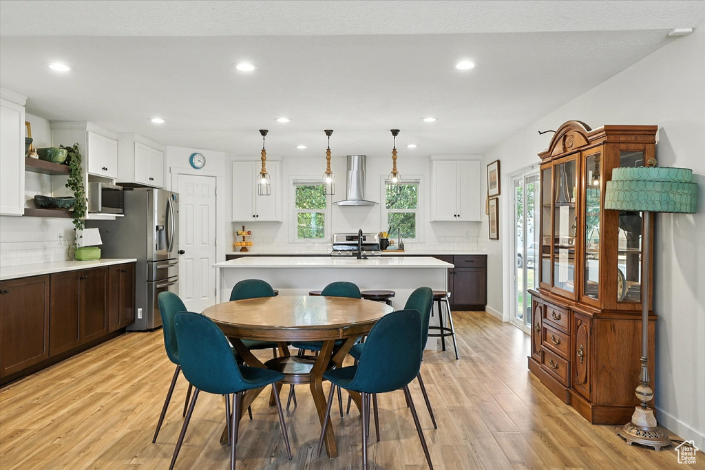 Dining room featuring light wood-style floors and recessed lighting