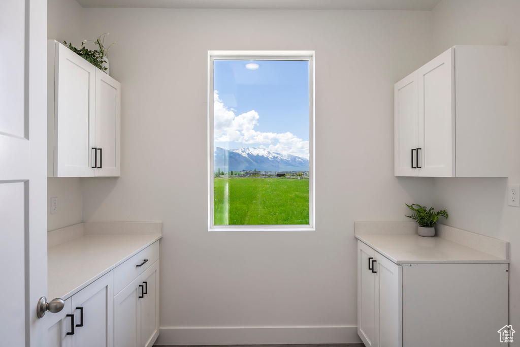 Laundry area featuring a mountain view and baseboards