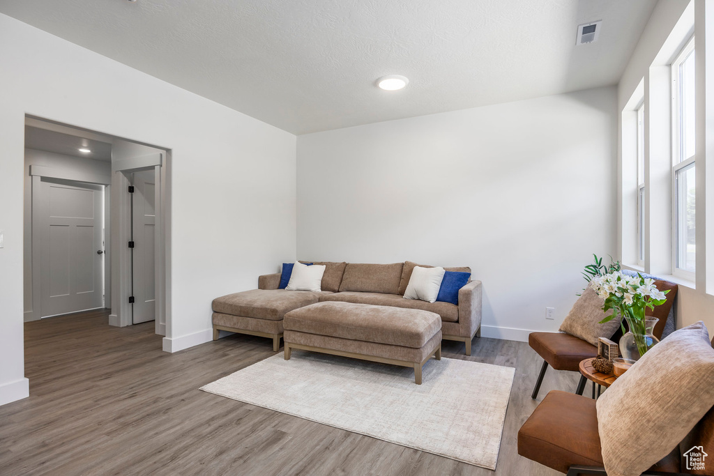 Living area featuring wood finished floors and recessed lighting