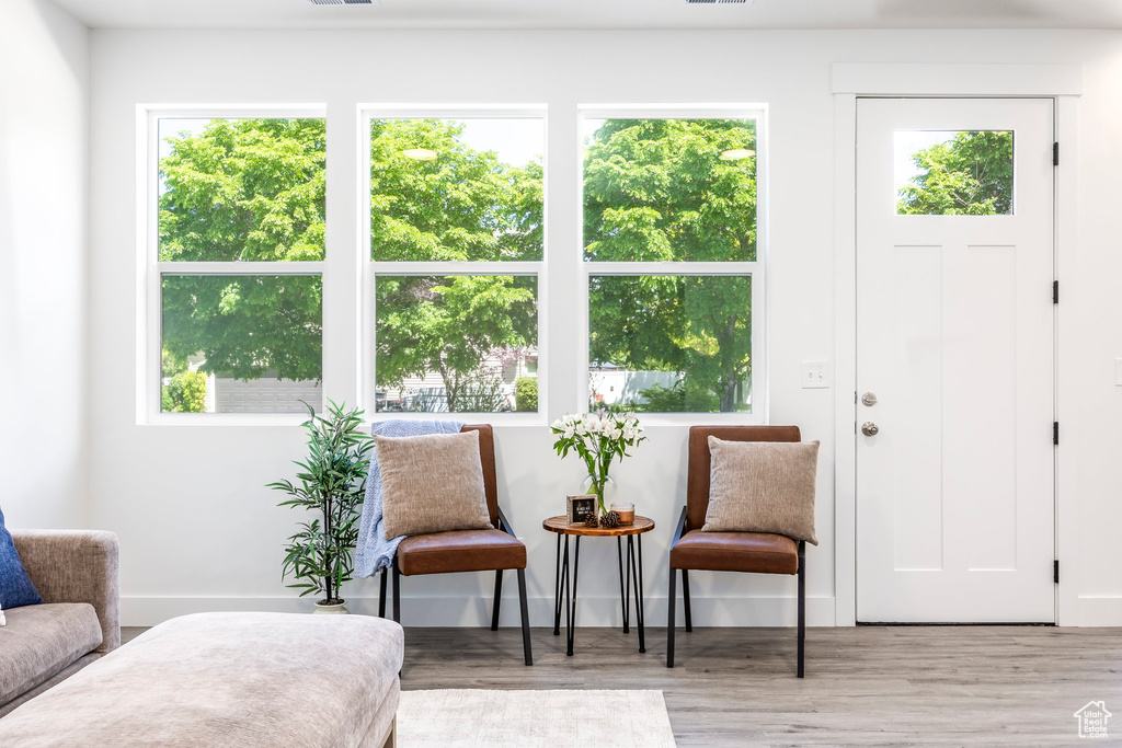 Living area with healthy amount of natural light and wood finished floors