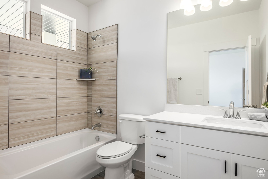 Bathroom with vanity,  shower combination, and wood finished floors