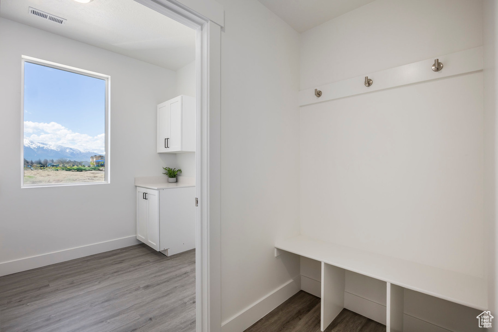 Mudroom with wood finished floors and baseboards