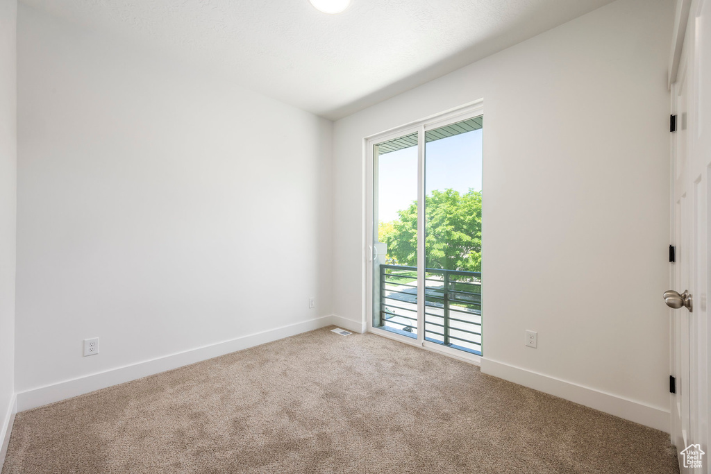 Unfurnished room featuring carpet and baseboards