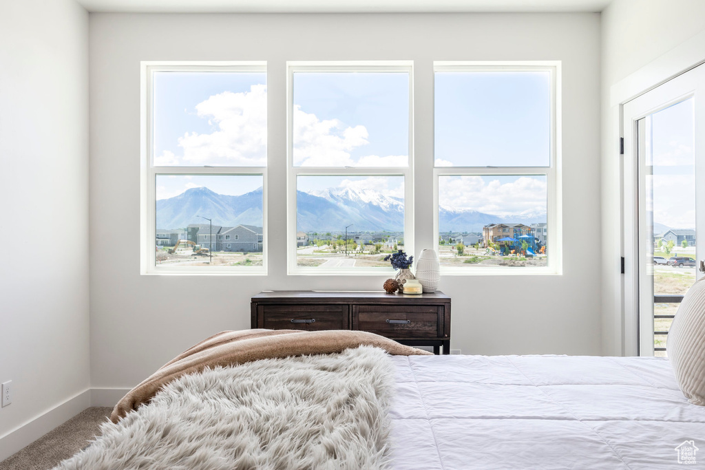Bedroom featuring carpet and a mountain view