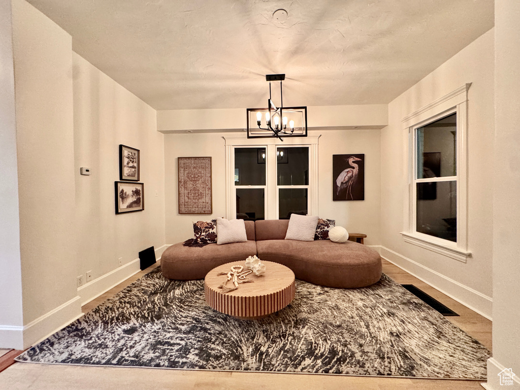 Living area with a chandelier and wood finished floors