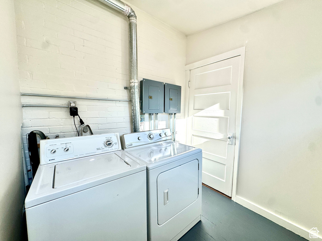 Laundry room with washer and clothes dryer and electric panel