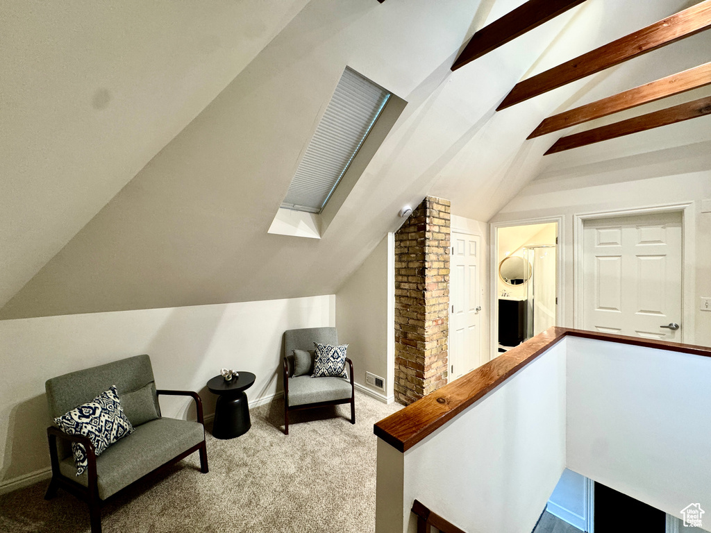 Living area with carpet floors and a skylight