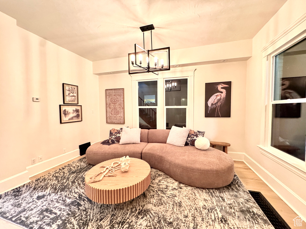 Living room featuring a chandelier and wood finished floors