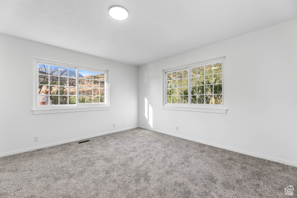 Unfurnished room featuring carpet flooring and baseboards