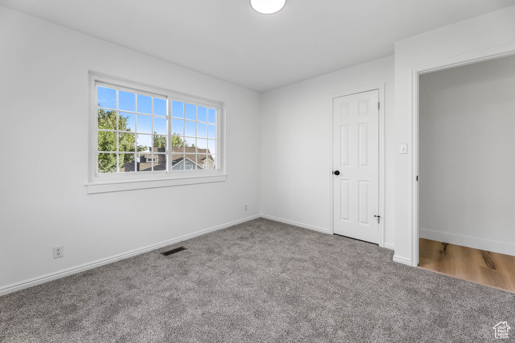 Unfurnished bedroom featuring carpet flooring and baseboards