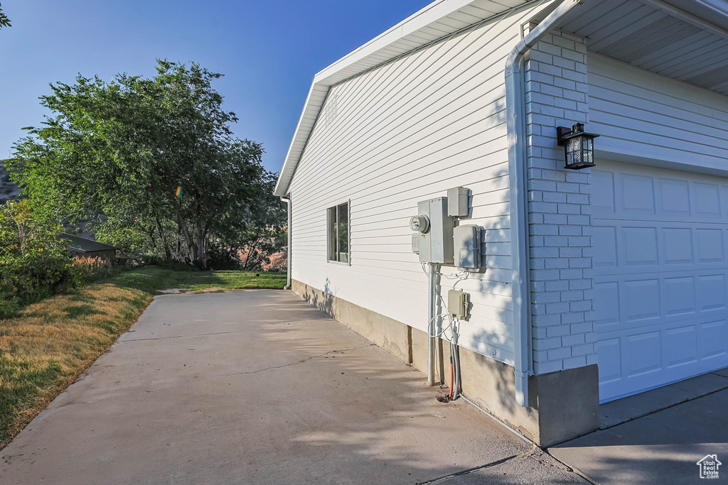 View of home's exterior with a garage and brick siding