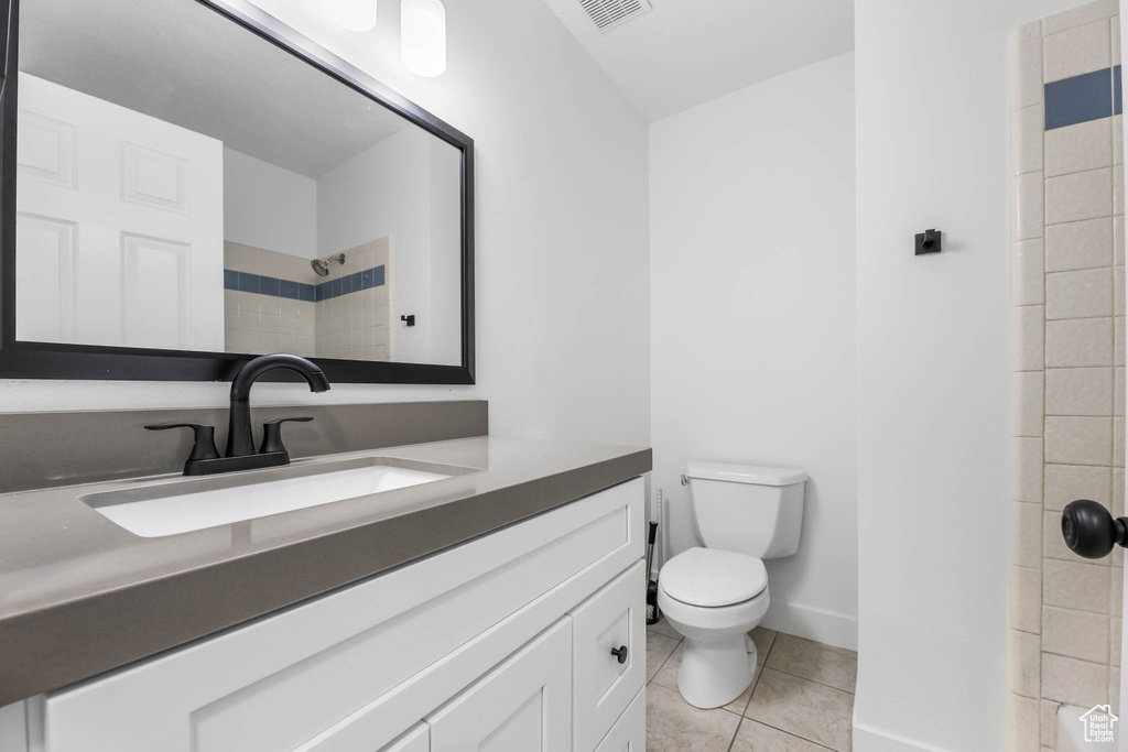 Bathroom featuring vanity, tile patterned floors, and a shower